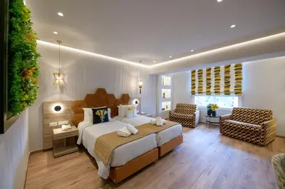 a bedroom with a large bed and a living room at Congo Palace in Athens