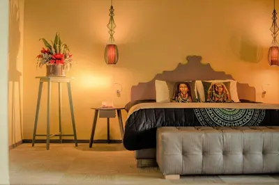 a bedroom with a bed with two women on it at Congo Palace in Athens