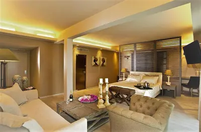 a living room with a couch and a bed and a table at Congo Palace in Athens