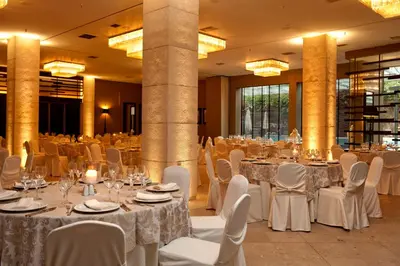 a banquet hall with white tables and chairs at Congo Palace in Athens