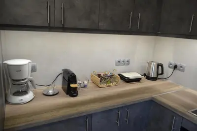 a kitchen counter with a coffee maker and a blender at Stergiou Luxury Apartments with shared pool in Anavissos