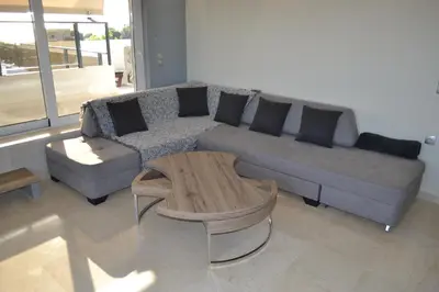 a living room with a couch and a coffee table at Stergiou Luxury Apartments with shared pool in Anavissos