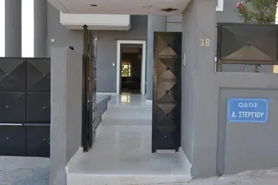 a building with a blue sign on the side of it at Stergiou Luxury Apartments with shared pool in Anavissos
