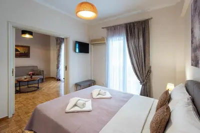 a bedroom with a bed with two white towels on it at Blue Ark Gate to History in Athens