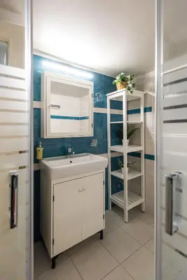 a bathroom with a sink and a mirror and a shelf at Blue Ark Gate to History in Athens