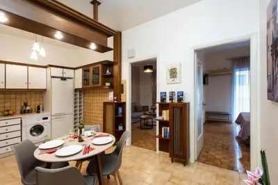 a kitchen and dining room with a table and chairs at Blue Ark Gate to History in Athens