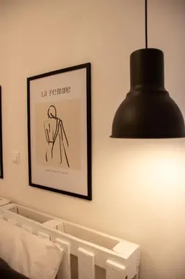 a black lamp and a picture on a wall at Apartment 7 in Athens