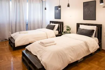 two beds sitting next to each other in a bedroom at Apartment 7 in Athens