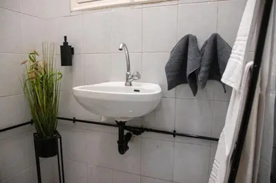 a bathroom with a sink and towels on the wall at Apartment 7 in Athens