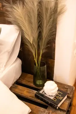 a table with a remote control and a vase on it at Apartment 7 in Athens