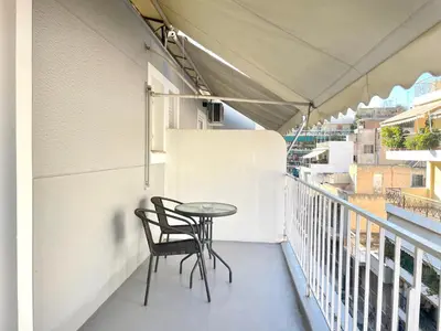 a balcony with a table and chairs on it at uoohome7 garden one bedroom in Athens