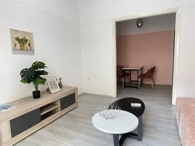 a living room with a table and a couch at uoohome7 garden one bedroom in Athens