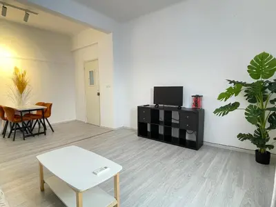 a living room with a table and a tv at uoohome7 garden one bedroom in Athens