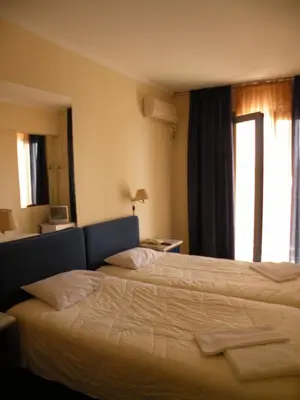 a hotel room with a bed and a window at Delfini Hotel in Piraeus