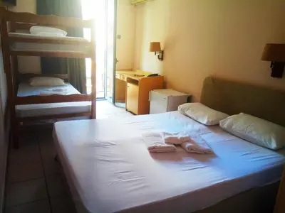 a bedroom with a bed with two towels on it at Delfini Hotel in Piraeus