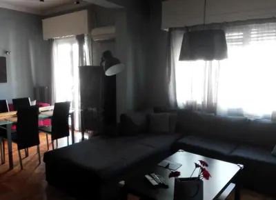 a living room with a couch and a table at Exarchia Square central Athens 110m2 apartment in Athens