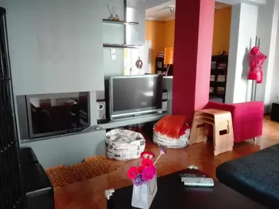 a living room with a flat screen tv and a couch at Exarchia Square central Athens 110m2 apartment in Athens
