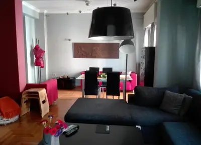 a living room with a couch and a table at Exarchia Square central Athens 110m2 apartment in Athens