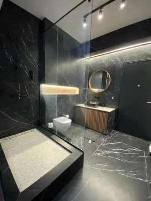 a bathroom with a shower with a toilet and a mirror at Athens Center Boutique Suites in Athens