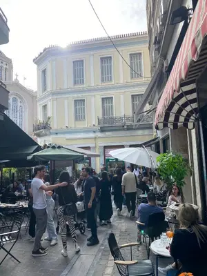 a group of people walking around an outdoor market at Athens Center Boutique Suites in Athens