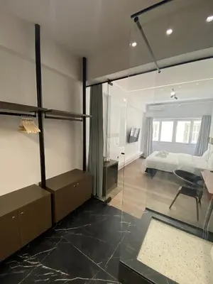 a bedroom with a bed and a glass wall at Athens Center Boutique Suites in Athens