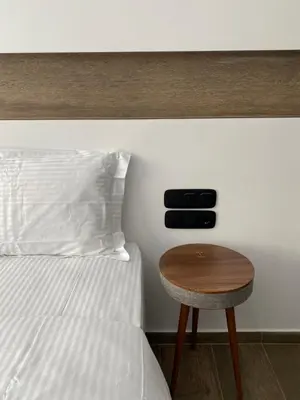 a bed with a wooden table next to a bed with at Athens Center Boutique Suites in Athens