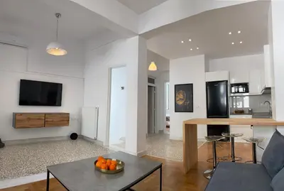 a living room with a couch and a table at Modern 3BR Maisonette with garden 10 min from Acropolis in Athens