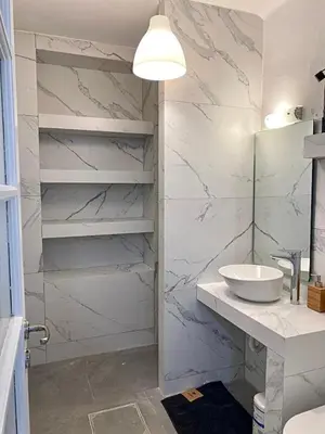 a white bathroom with a sink and a mirror at Modern 3BR Maisonette with garden 10 min from Acropolis in Athens