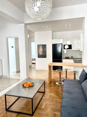 a living room with a couch and a table at Modern 3BR Maisonette with garden 10 min from Acropolis in Athens