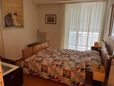 a bedroom with a bed with a quilt on it at Spacious and sunny appartment in Cholargos in Athens