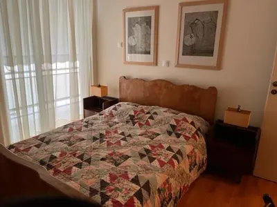 a bedroom with a bed with a quilt on it at Spacious and sunny appartment in Cholargos in Athens