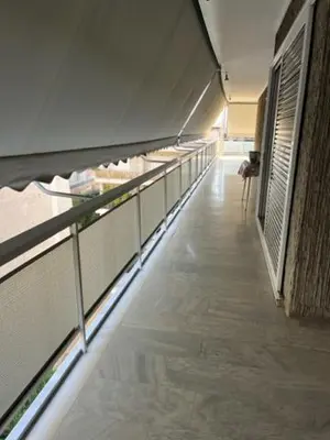 a hallway of a building with a long line of windows at Spacious and sunny appartment in Cholargos in Athens