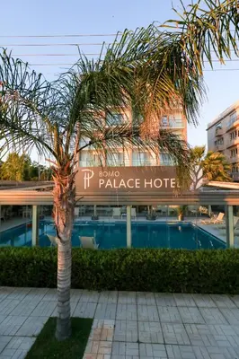 a palm tree in front of a palace hotel at Palace Hotel Glyfada in Athens