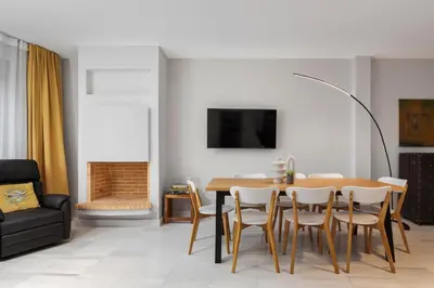 a dining room with a table and chairs at Varkiza Escape Residence in Vari