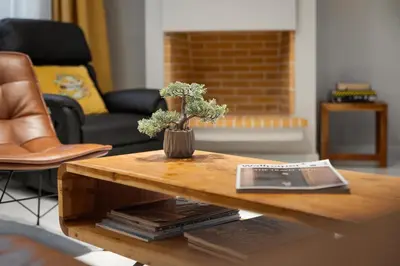 a coffee table with a vase of flowers on it at Varkiza Escape Residence in Vari