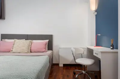 a bedroom with a bed and a desk and a chair at Varkiza Escape Residence in Vari