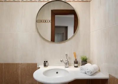a bathroom with a sink and a mirror at Varkiza Escape Residence in Vari