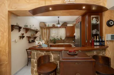 a kitchen with a bar in a house at Vintage Place Near ATH Airport in Markopoulo