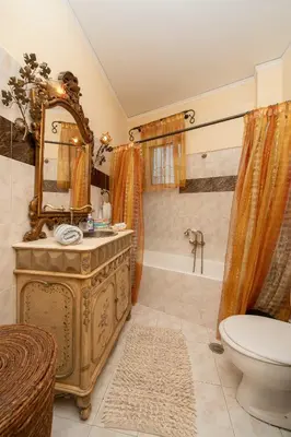 a bathroom with a sink and a toilet and a mirror at Vintage Place Near ATH Airport in Markopoulo
