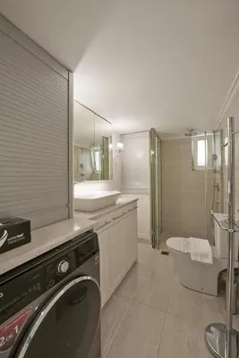a bathroom with a washing machine and a sink at Belva Blue Glyfada Modern 2BR Walk to Ctr & Beach in Athens