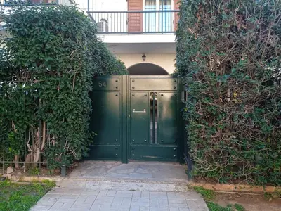 a green door in the middle of a building at Belva Blue Glyfada Modern 2BR Walk to Ctr & Beach in Athens