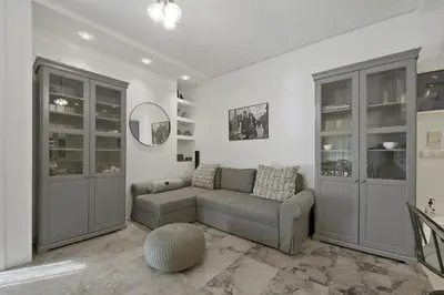 a living room with a couch and a mirror at Belva Blue Glyfada Modern 2BR Walk to Ctr & Beach in Athens