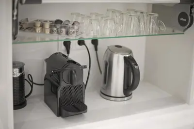 a coffee maker and a kettle on a shelf at Belva Blue Glyfada Modern 2BR Walk to Ctr & Beach in Athens