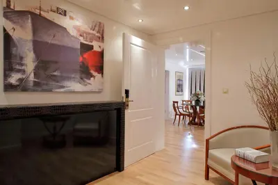 a living room with a fireplace and a television at Piraeus Theoxenia Hotel in Piraeus