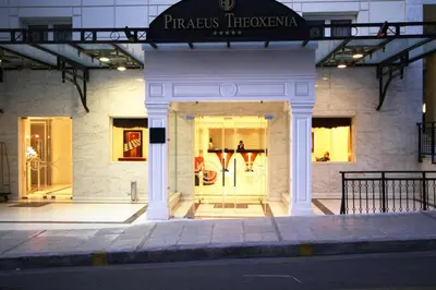 a store front of a building at night at Piraeus Theoxenia Hotel in Piraeus