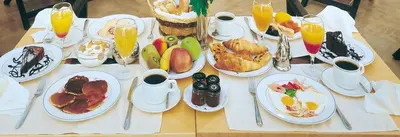 a table with plates of breakfast food on it at Piraeus Theoxenia Hotel in Piraeus