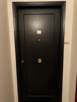 a black door with a sticker on it at SIS Urban Apartments in Athens