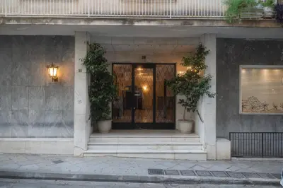 a front door of a building with two potted plants at SIS Urban Apartments in Athens