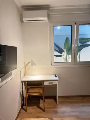 a desk with a lamp and a window in a room at SIS Urban Apartments in Athens