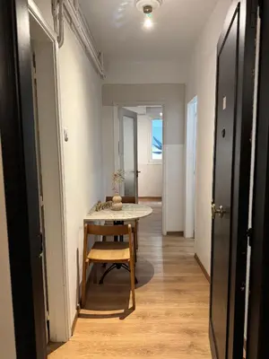 a hallway with a table and a chair in a room at SIS Urban Apartments in Athens
